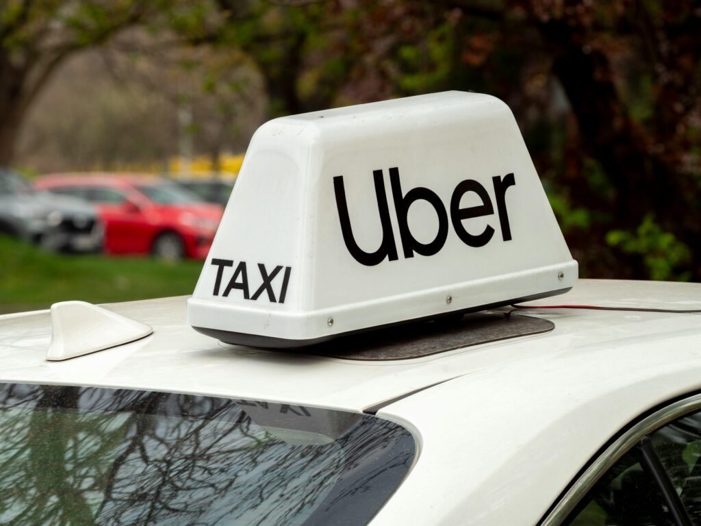 White car with an Uber sign on the roof, representing rideshare accident injury claims handled by our Burbank personal injury lawyer.