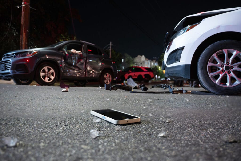 A personal injury attorney at personalinjury365.com discussing a vehicle accident claim with a male client in an arm sling.